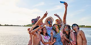 Family at the beach taking selfies